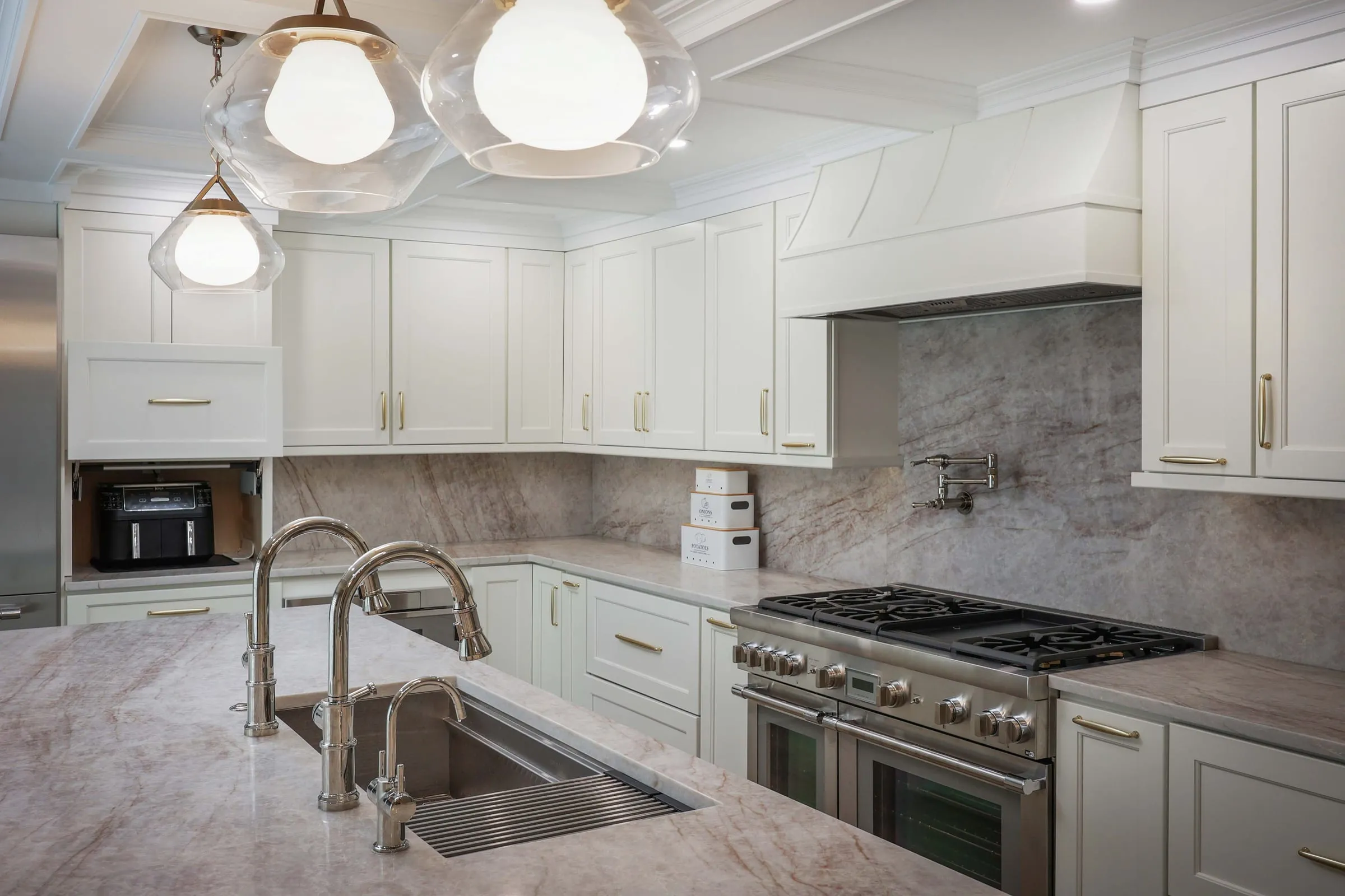 Schoolhouse pendants over a marble island