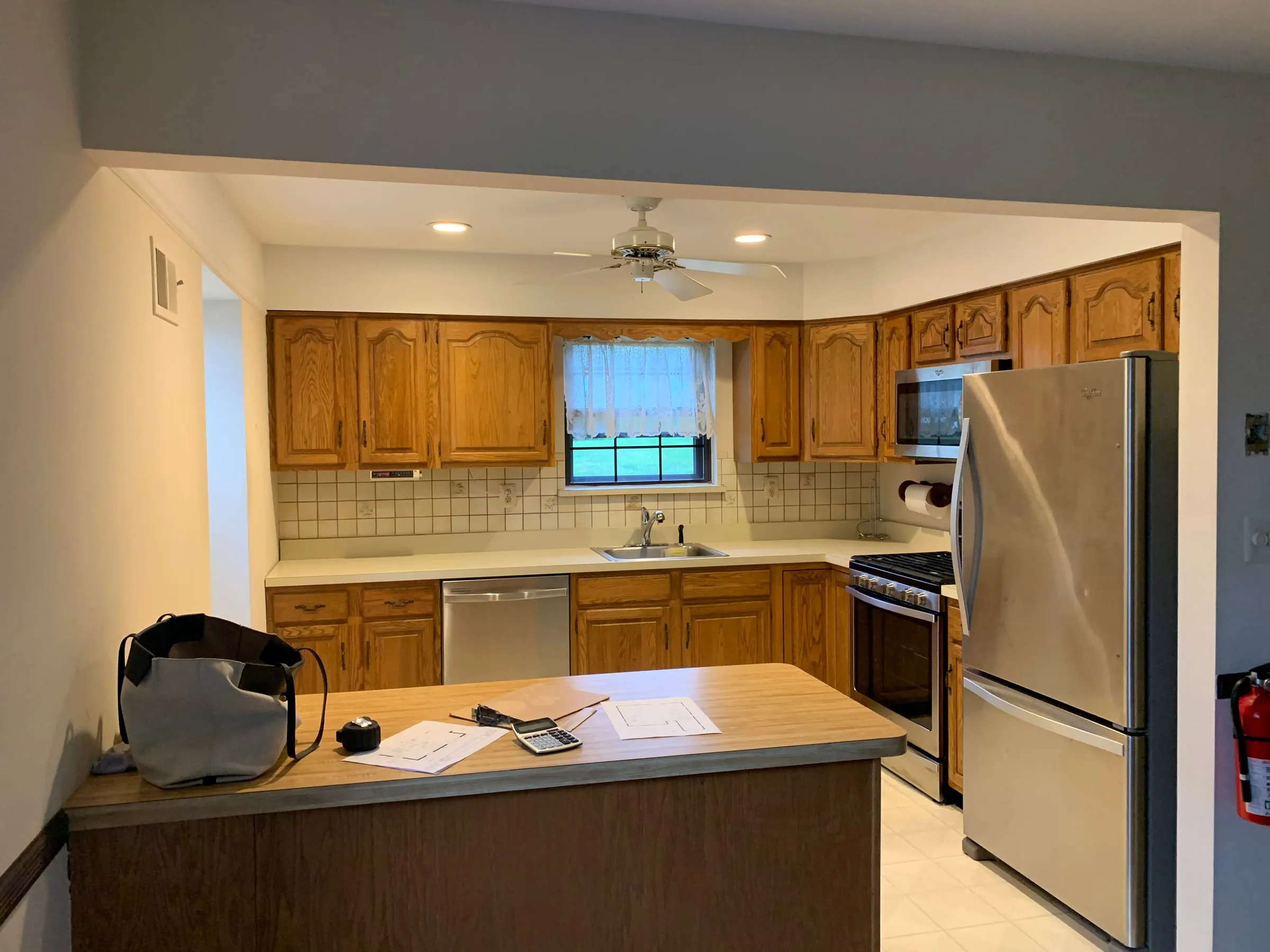 Before: Oak cabinets to white shaker